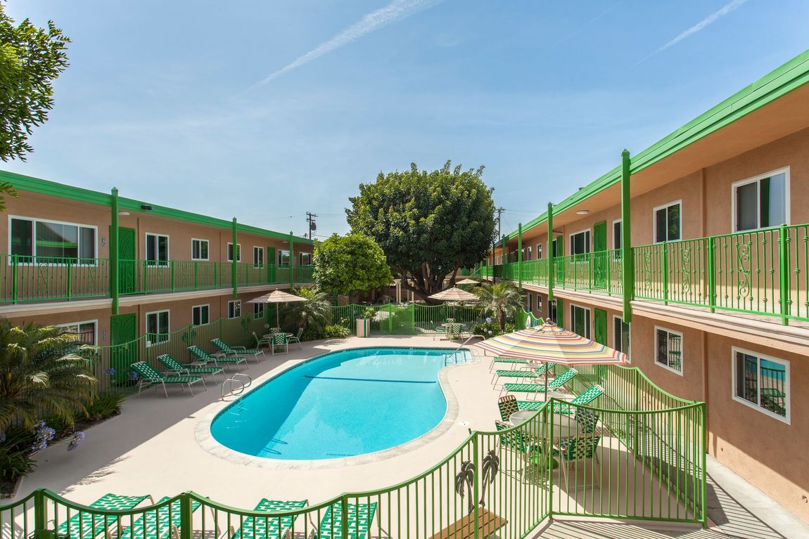 A hotel with a large swimming pool in the middle of it