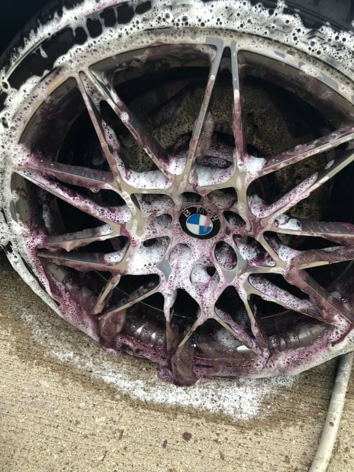 a set of gold wheels and tires on a concrete floor