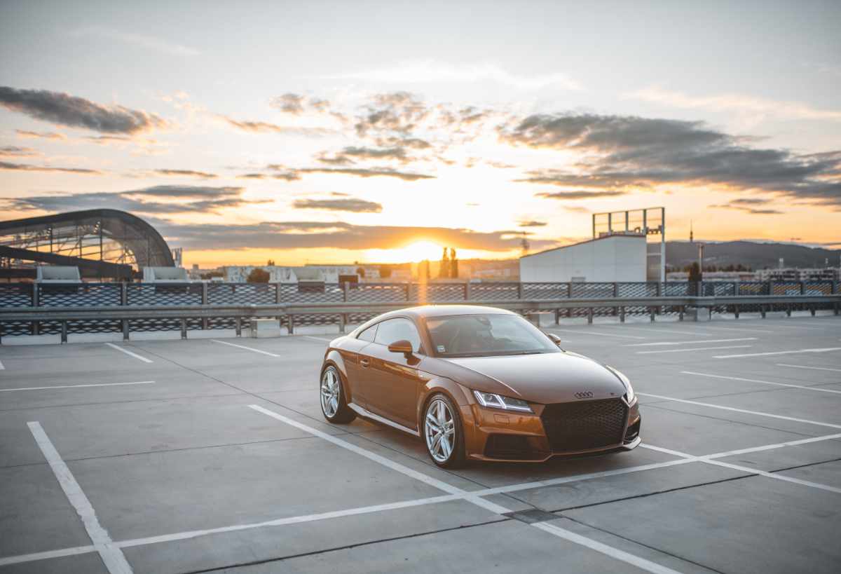 polished bronze Audi parked in empty lot