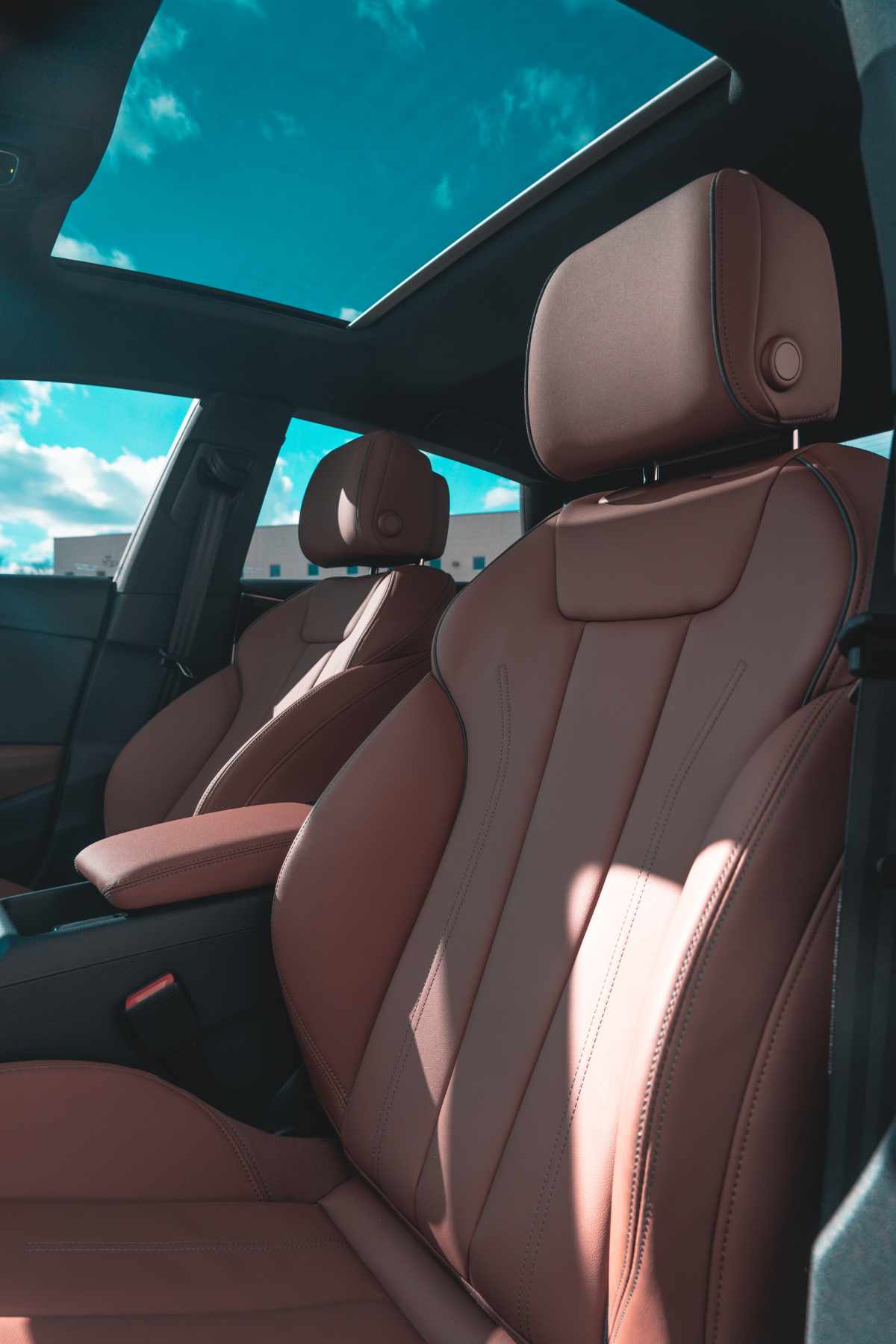 a brown audi is parked on the side of the road .