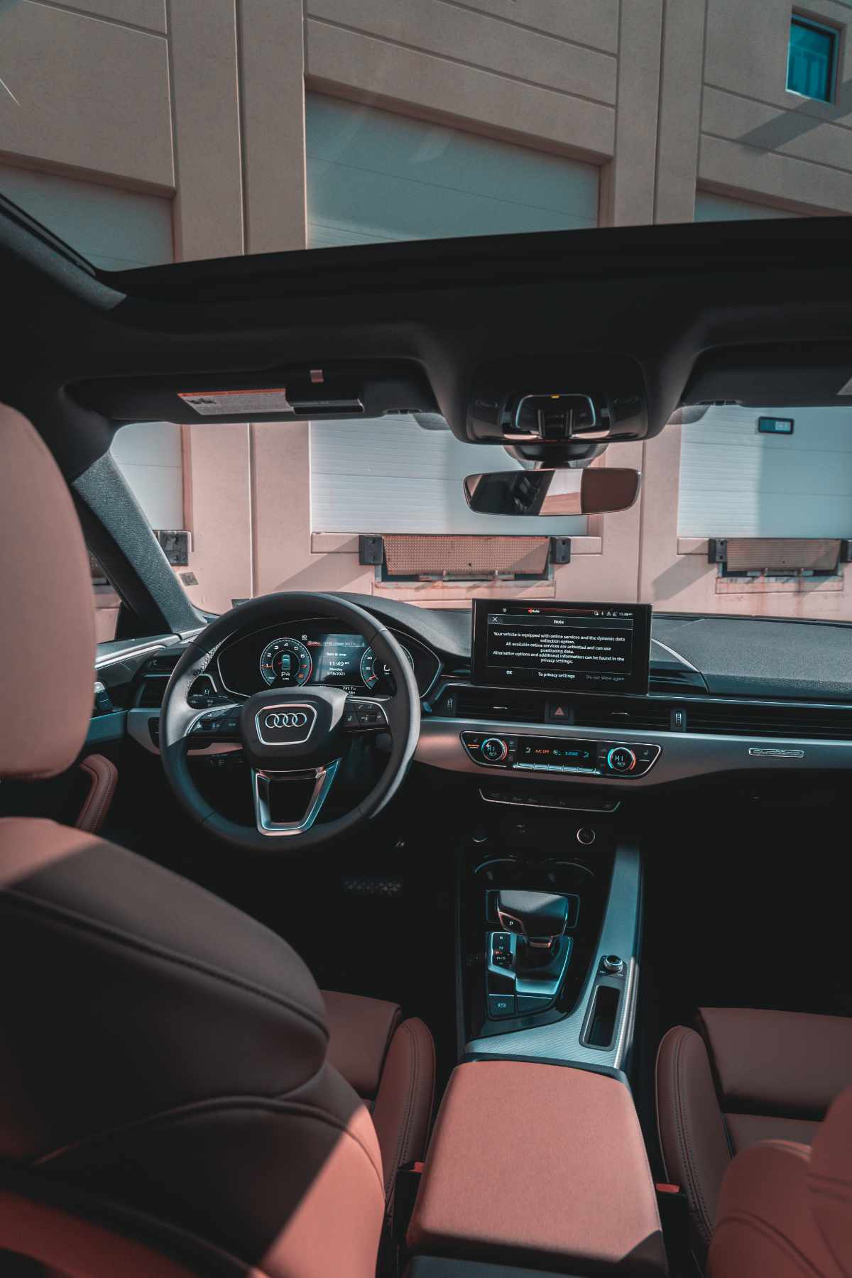 Audi with tan brown leather interior and open sunroof