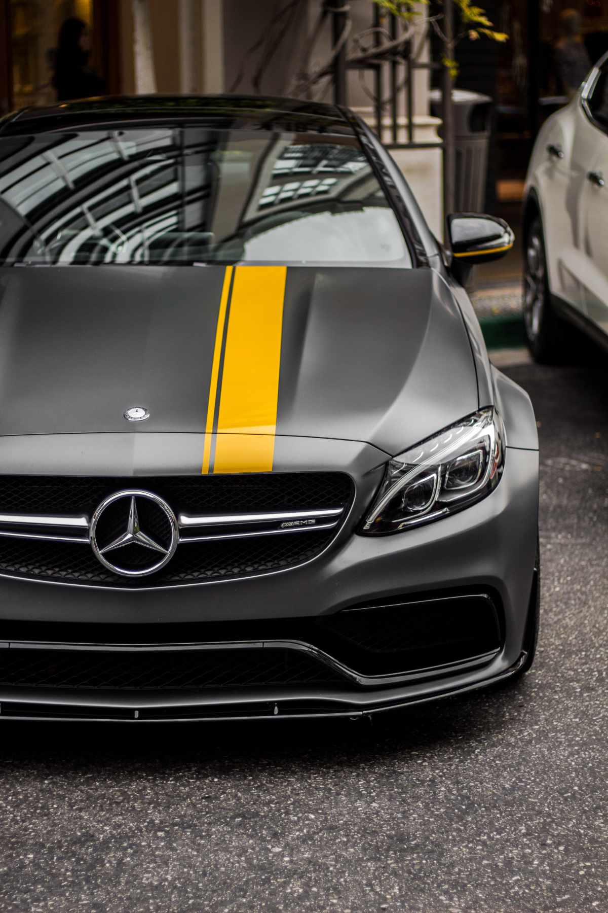 sliver Benz with a yellow stripe on the hood