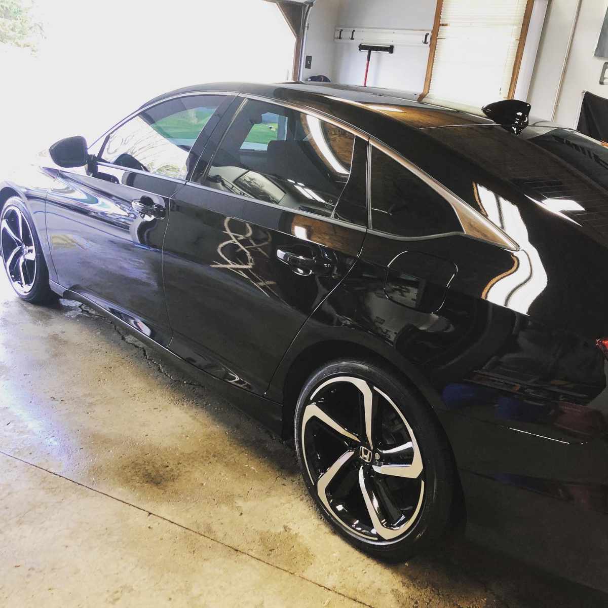 glossy black car in a garage