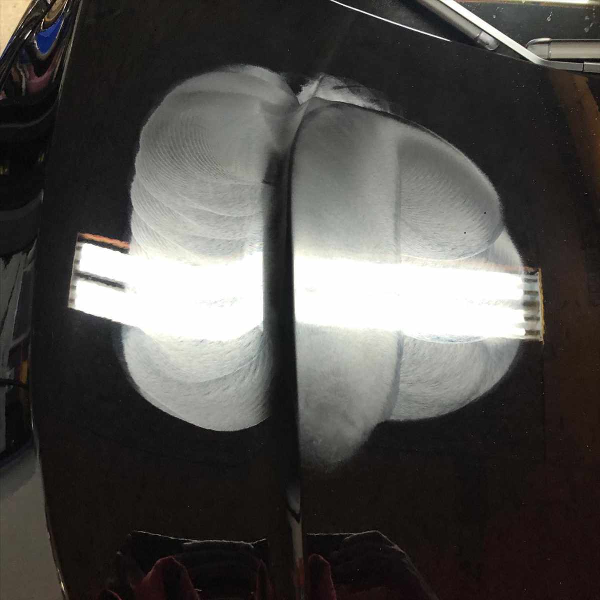 shiny black hood with compound product swirls