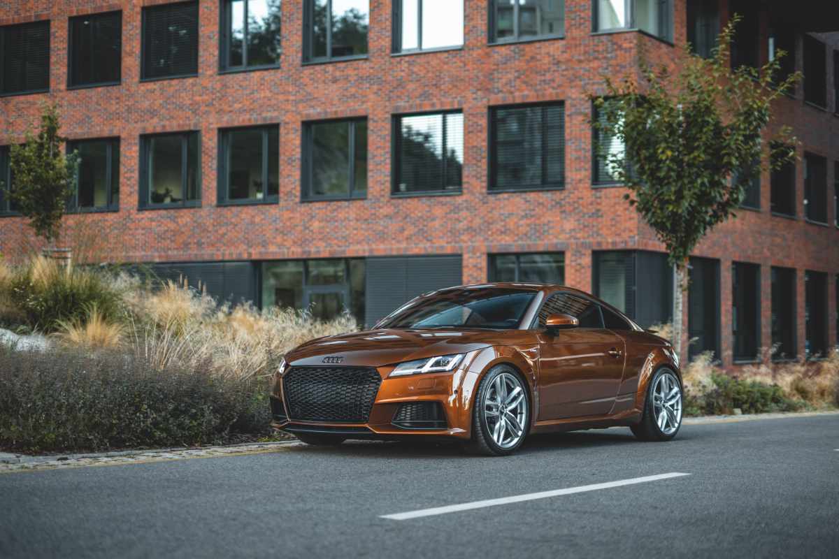 polished bronze Audi parked on street
