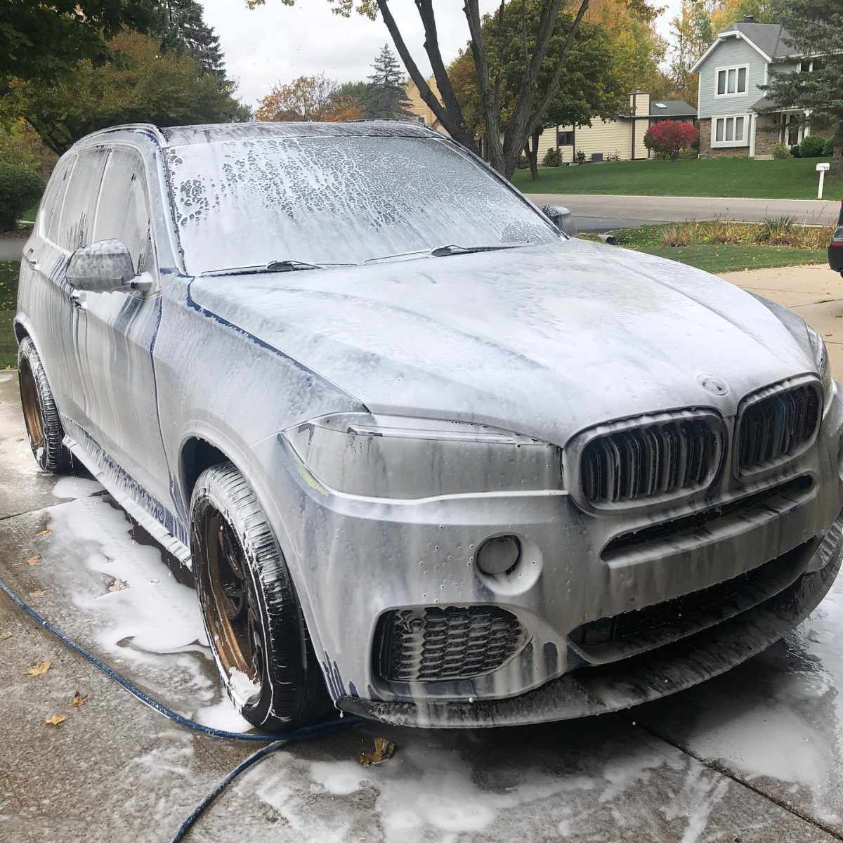 snow foam covered grey suv front