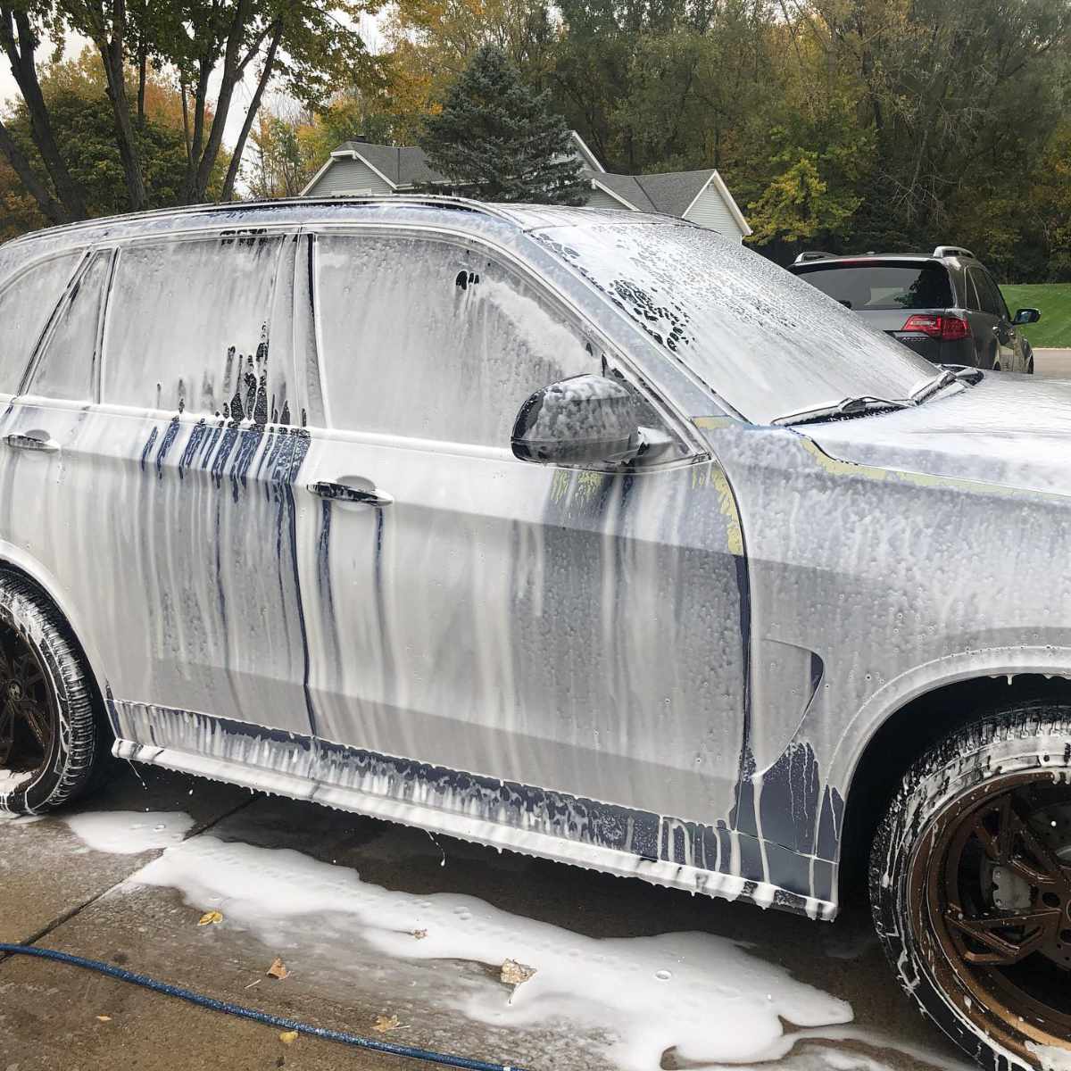 snow foam covered grey suv side
