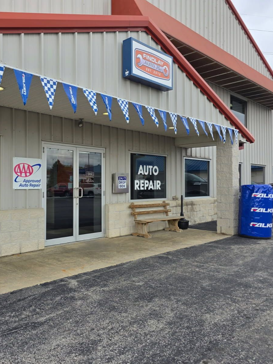Auto repair shop with white and red exterior, sign 