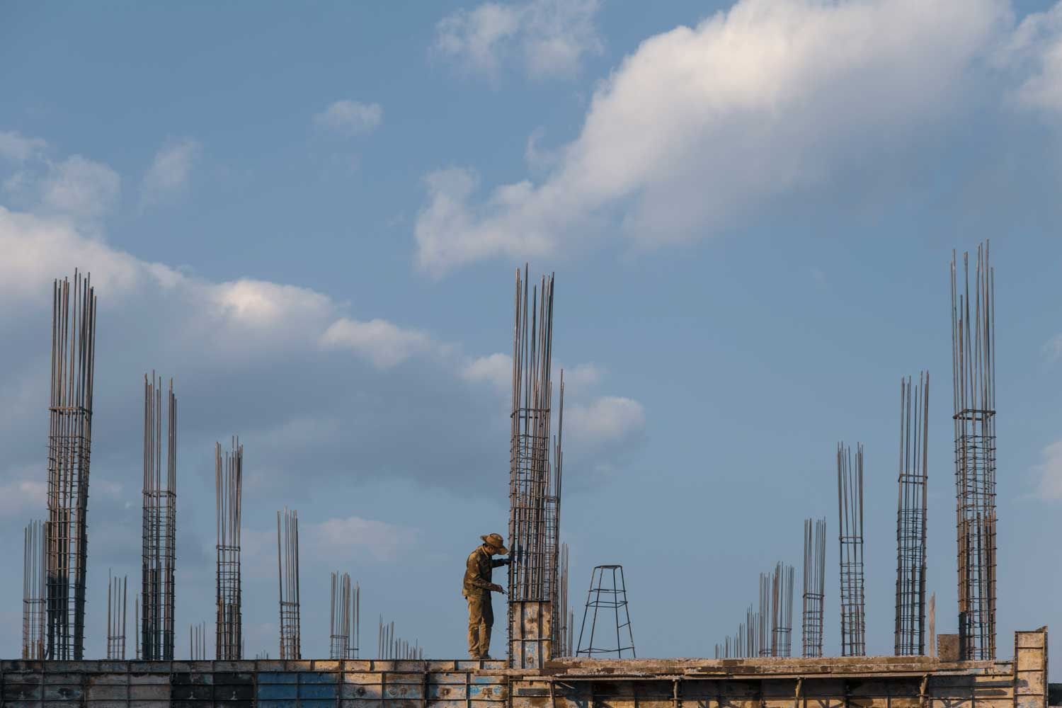 Construction worker on a concrete structure with rebar