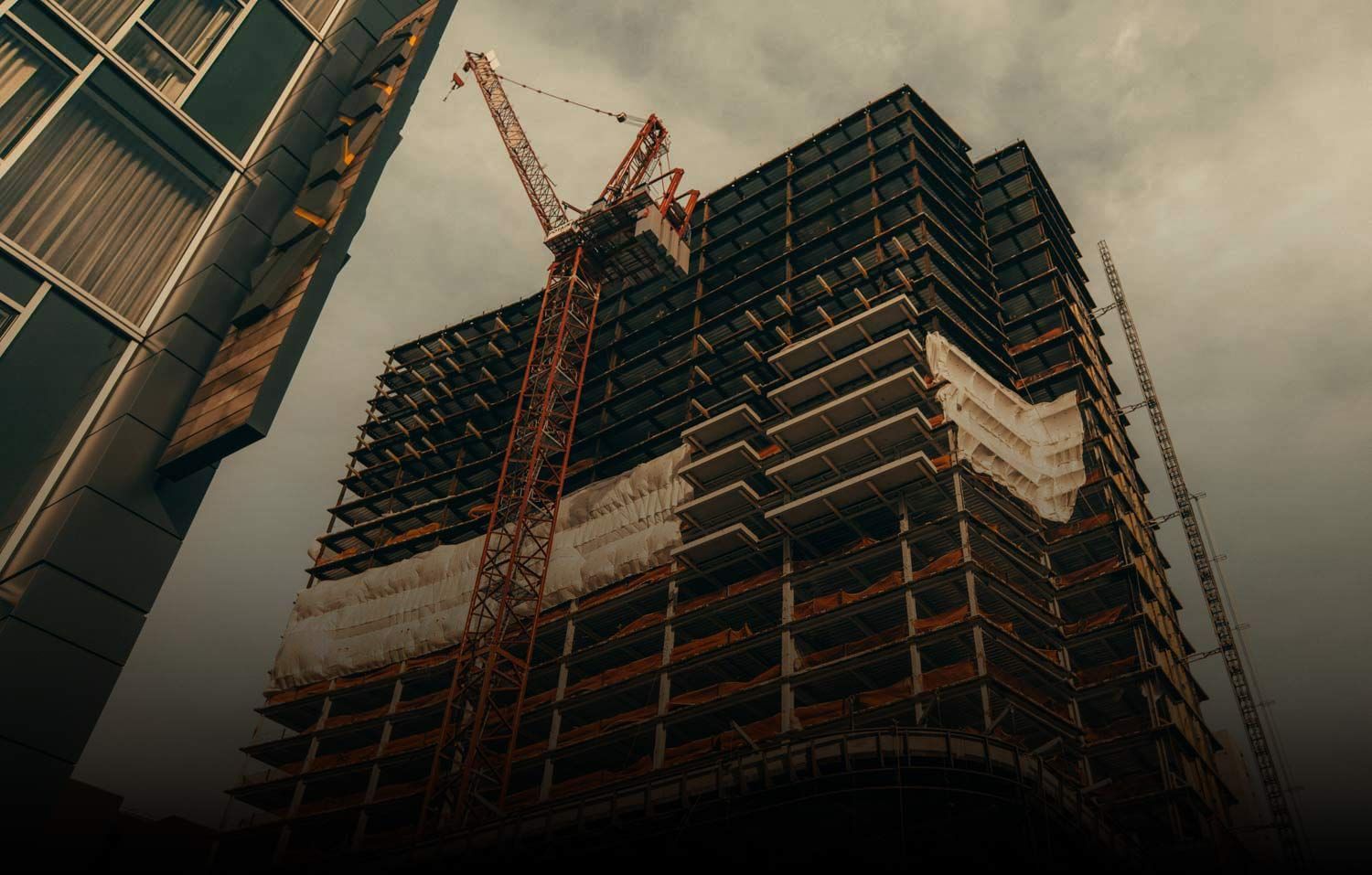 Tall building under construction with a crane