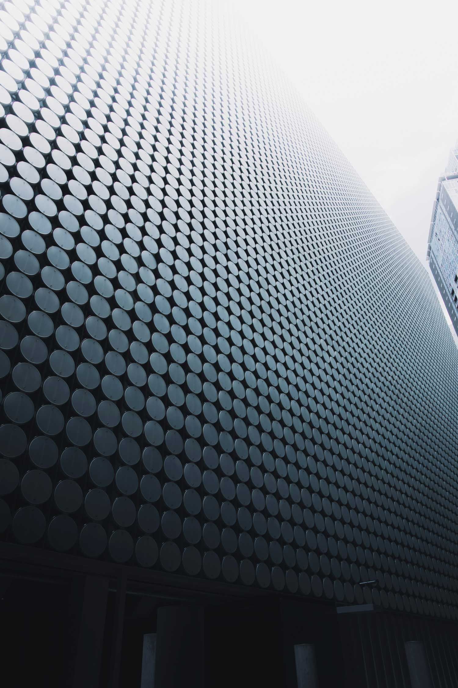 Building facade covered in circular metal discs