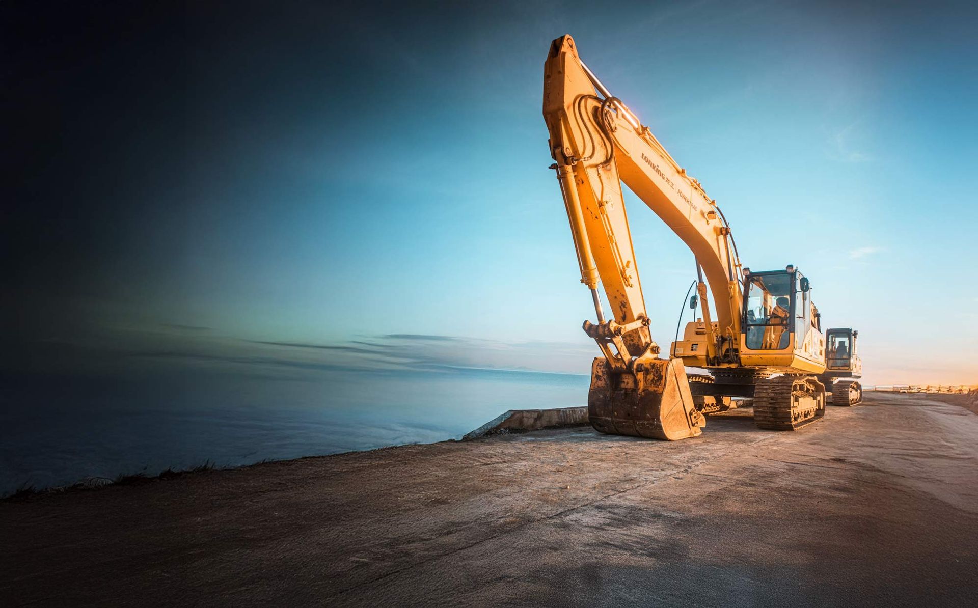 Yellow excavator on a dirt road