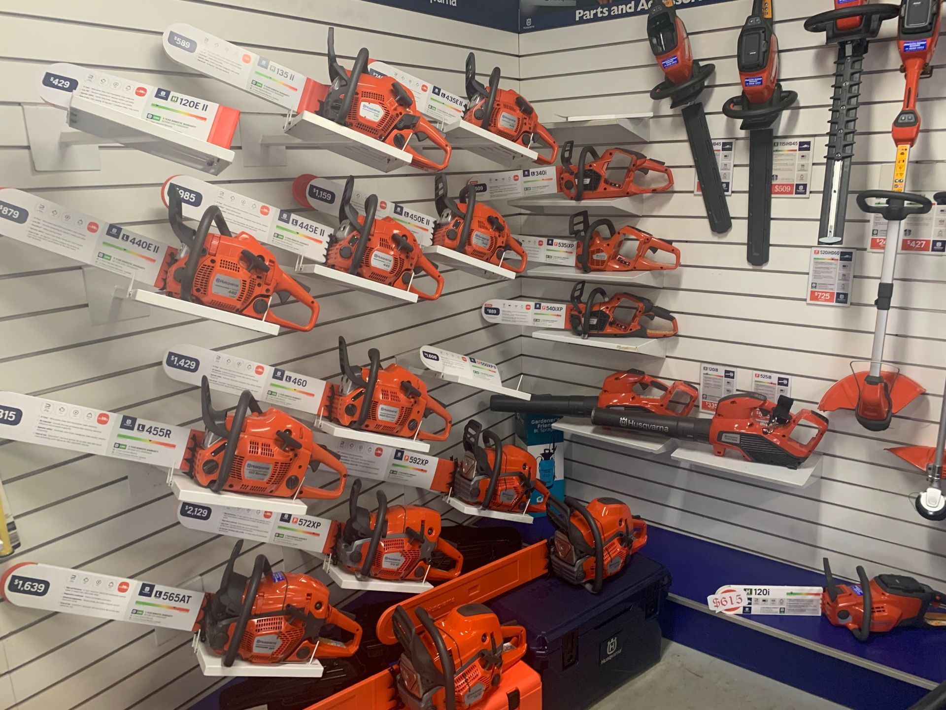 A range of chainsaws displayed on the shelf at an outdoor equipment store — Gloucester Outdoor Solutions In Stroud, NSW