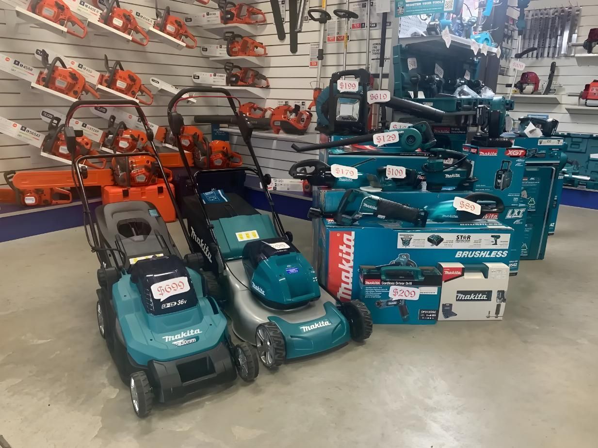 A Bunch of Lawn Mowers Are Sitting on Top of Each Other in a Store — Gloucester Outdoor Solutions In Gloucester, NSW
