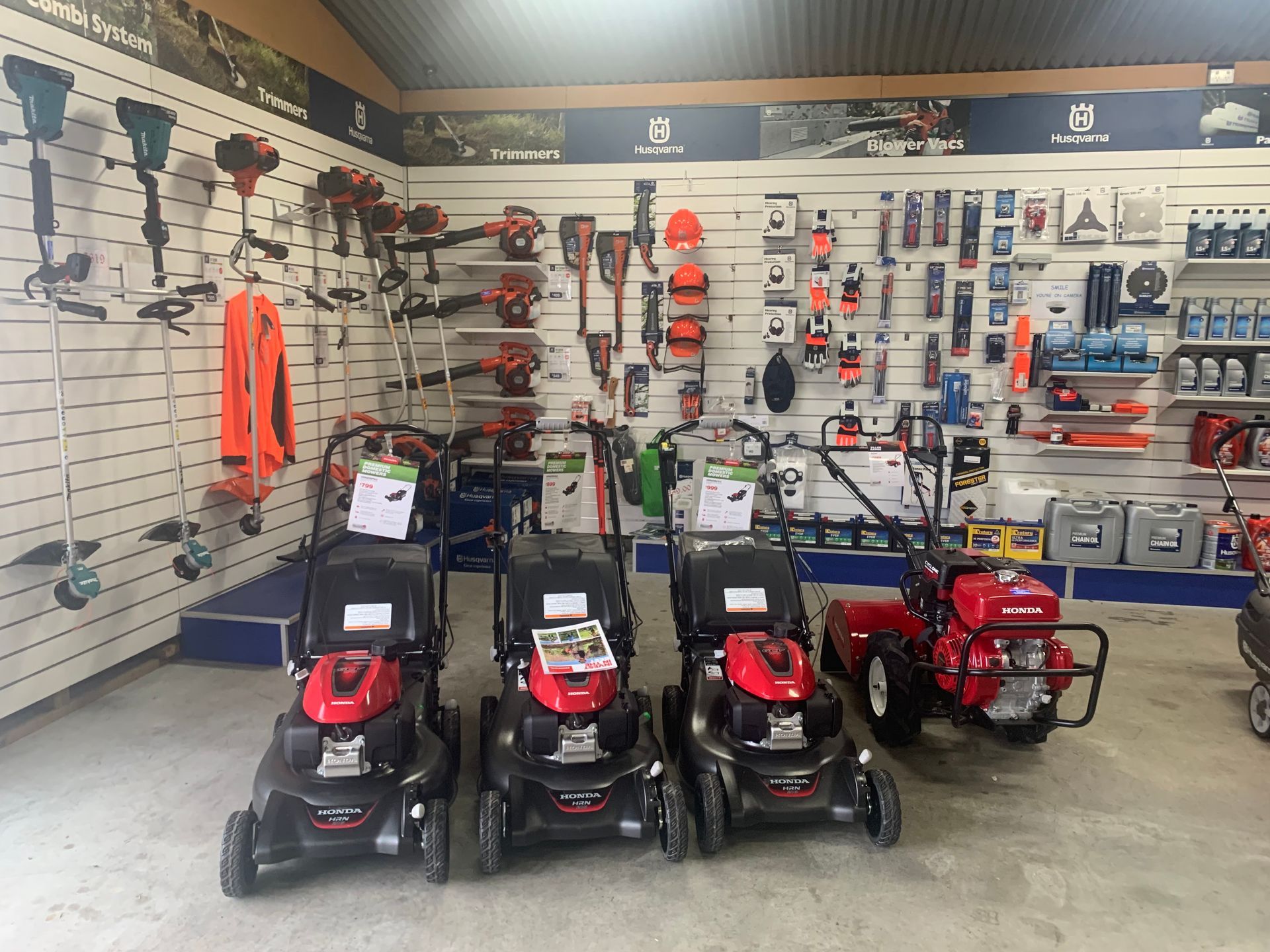 Man Trimming Grass Using Brushcutters — Gloucester Outdoor Solutions In Gloucester, NSW