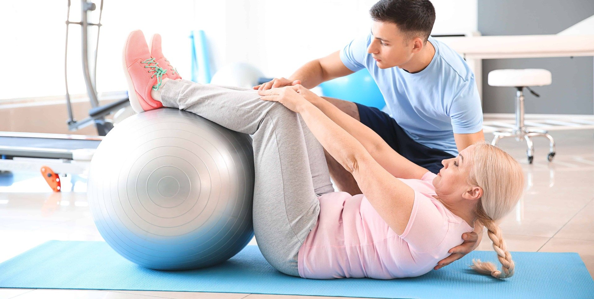 Image of a woman receiving physiotherapy treatment from a male physiotherapist.