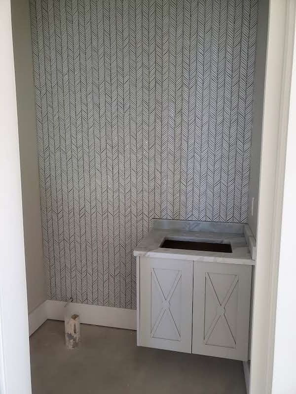 There is a sink in the corner of the room.