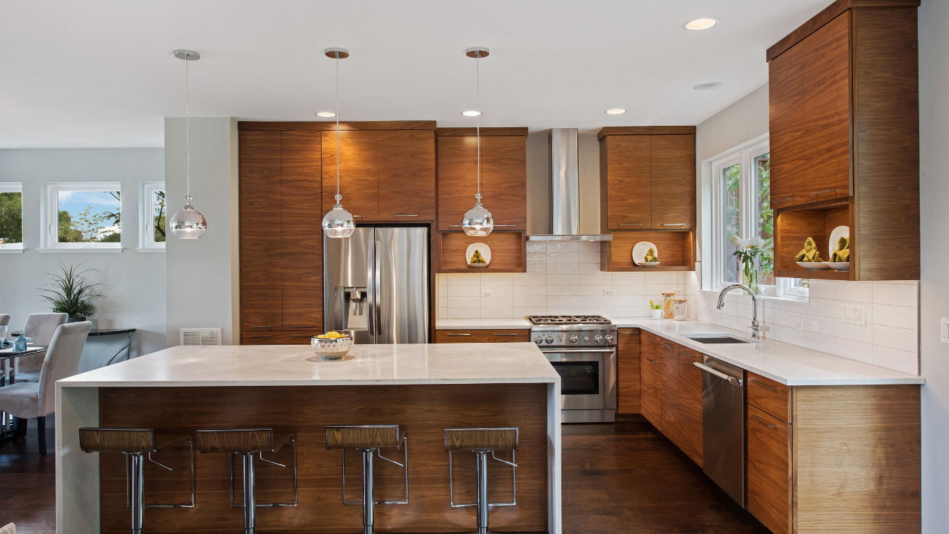 A kitchen with wooden cabinets , stainless steel appliances , and a large island.
