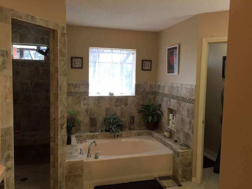 A bathroom with a large tub and a window