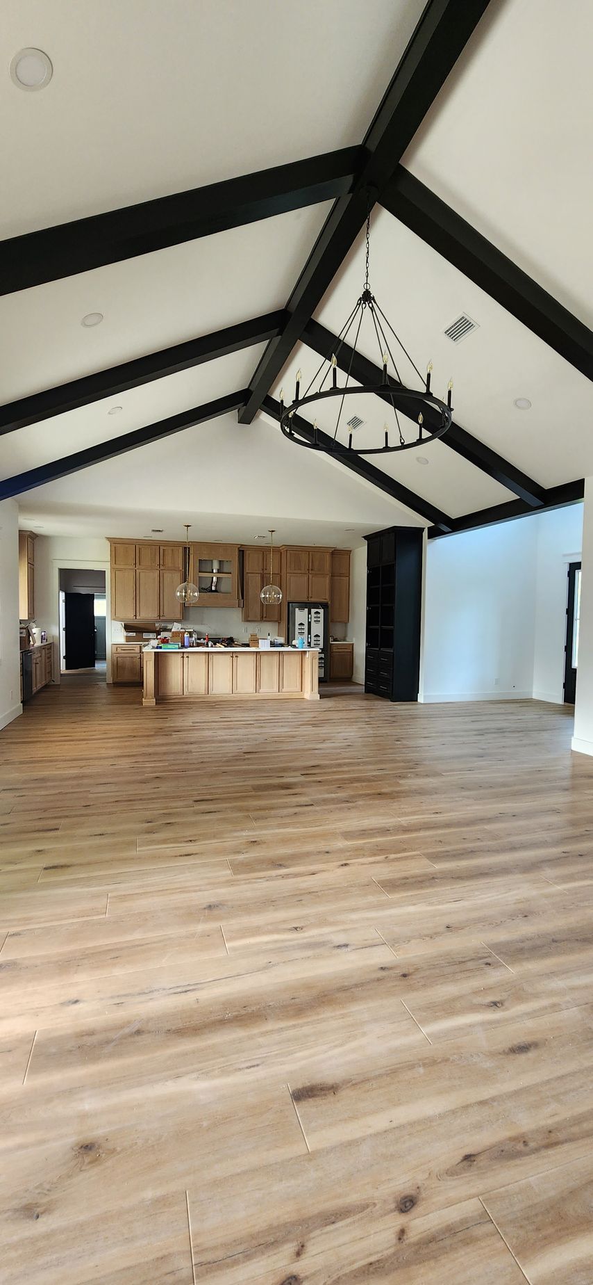 There is a bed in the middle of the room with a view of the mountains.