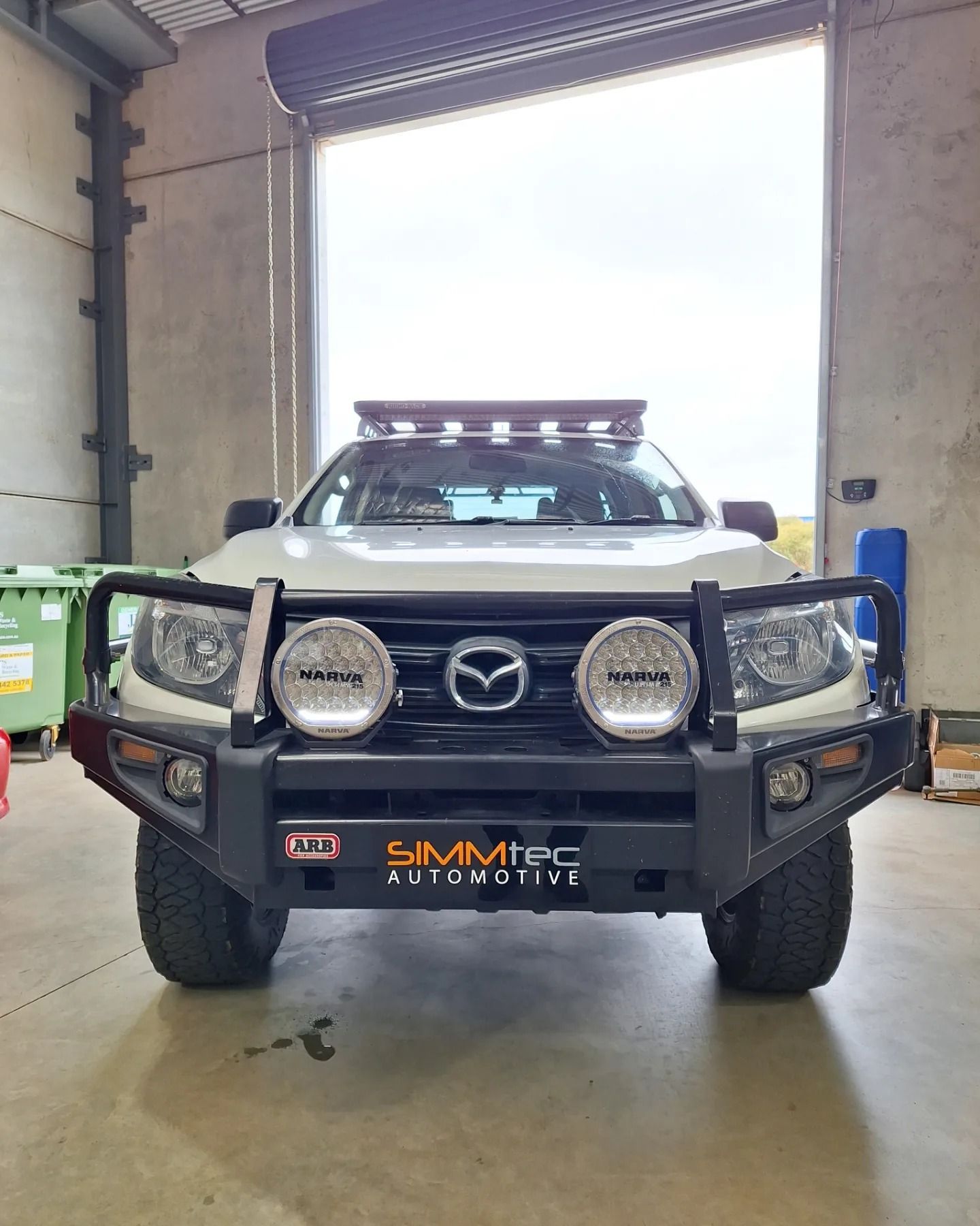 A white truck with a bumper and lights.
