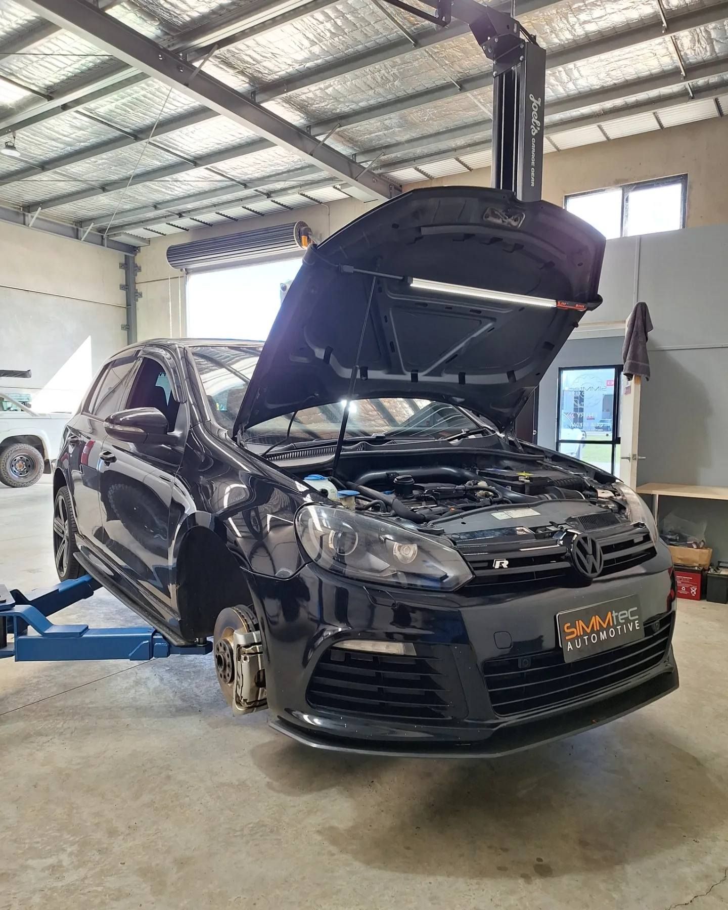 A black car with the hood open