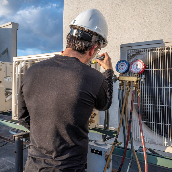 HVAC technician working on a commercial unit