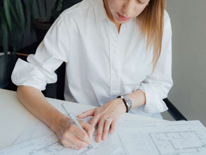 Contact Us - Woman Making a Bluprint