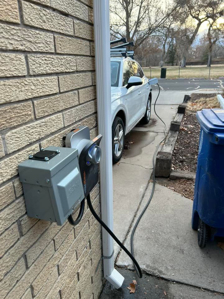 A Car Is Parked On The Side Of A Brick Building Next To A Trash Can | Albuquerque, NM | Tesla Electric LLC
