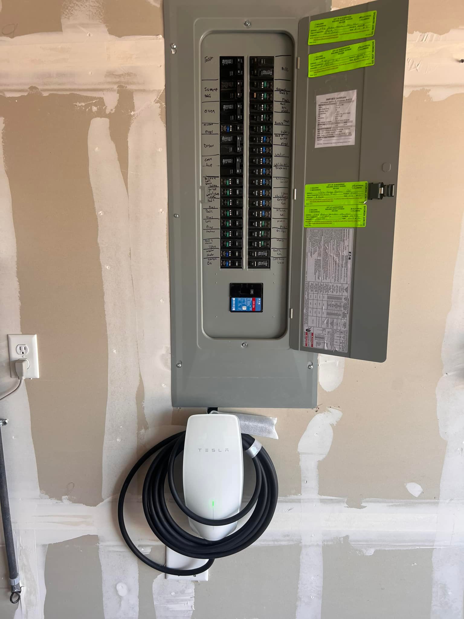 An Electrical Box Is Hanging On A Wall With A Cord Attached To It | Albuquerque, NM | Tesla Electric LLC