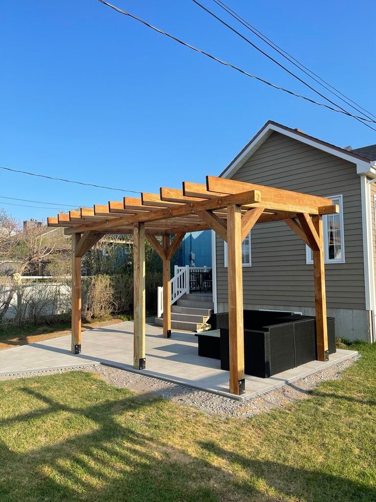 Une pergola en bois se trouve dans l'arrière-cour d'une maison.