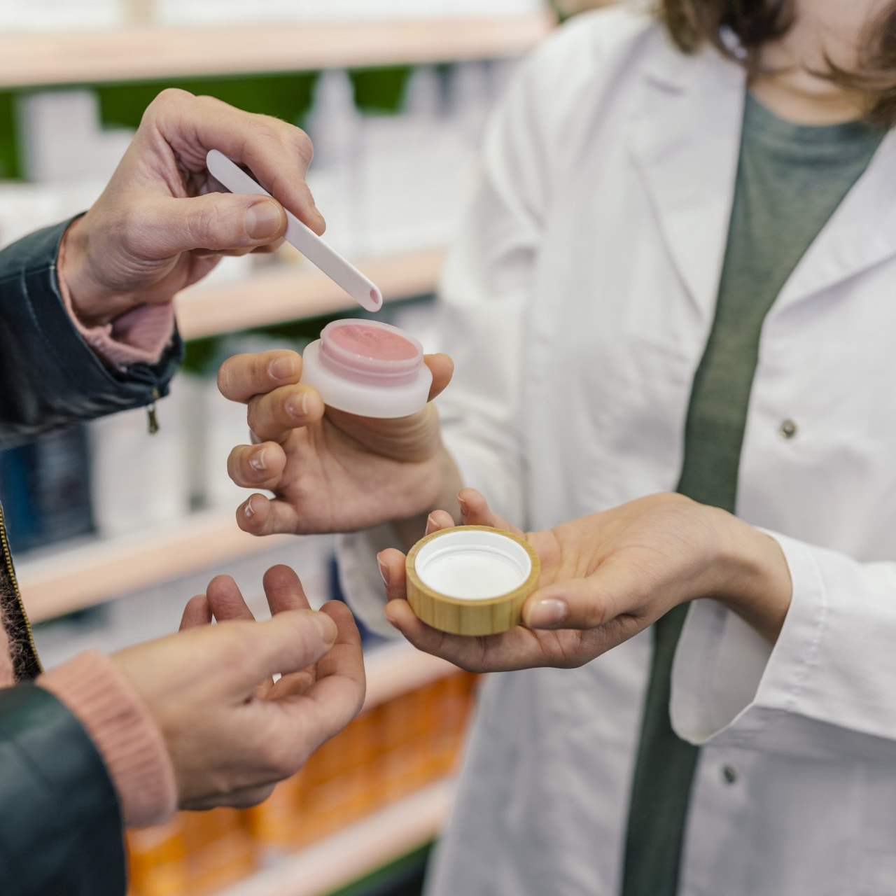 Customer testing cosmetics in pharmacy - stock photo