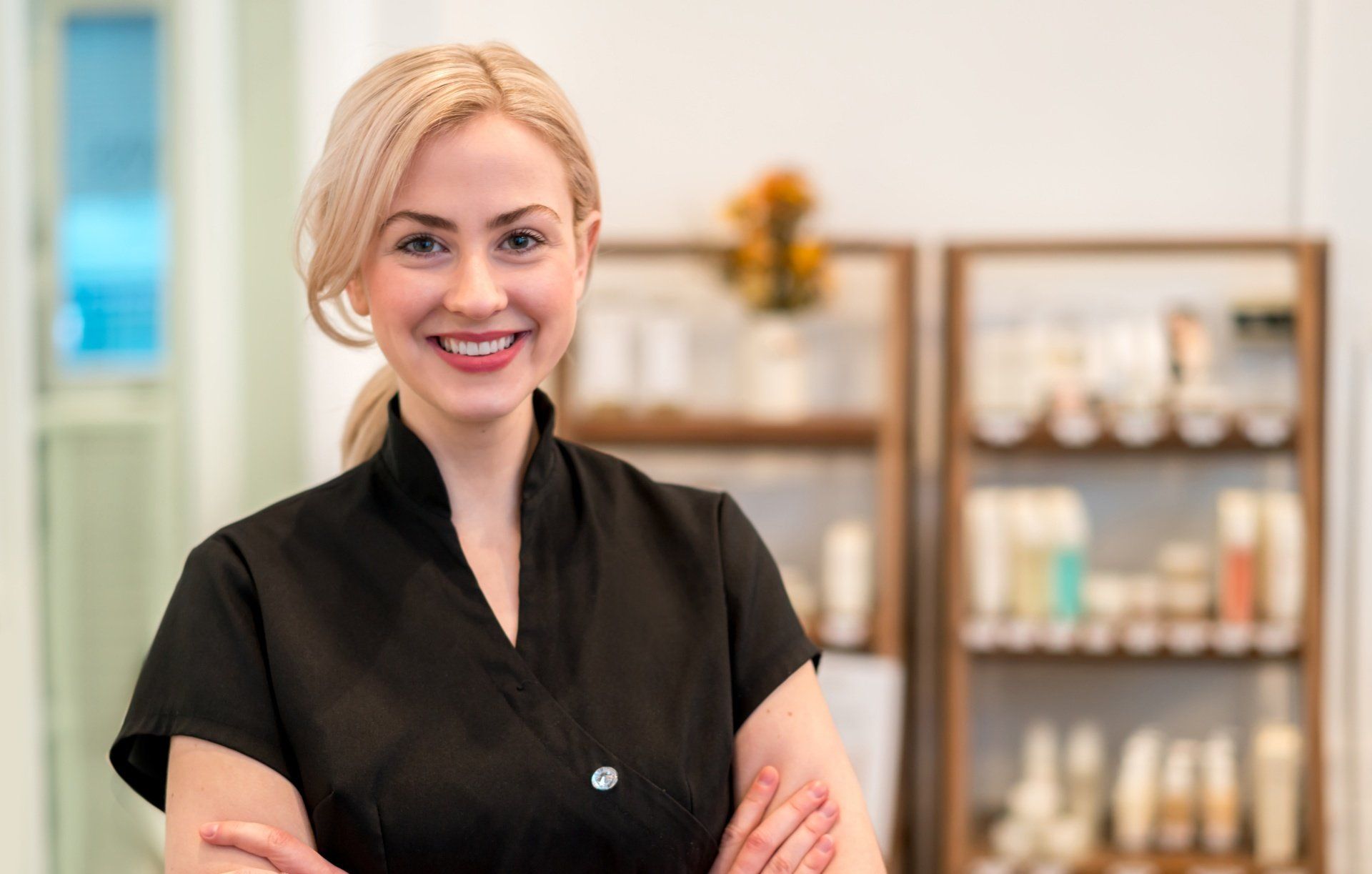 Portrait of a happy business owner working at a spa selling products