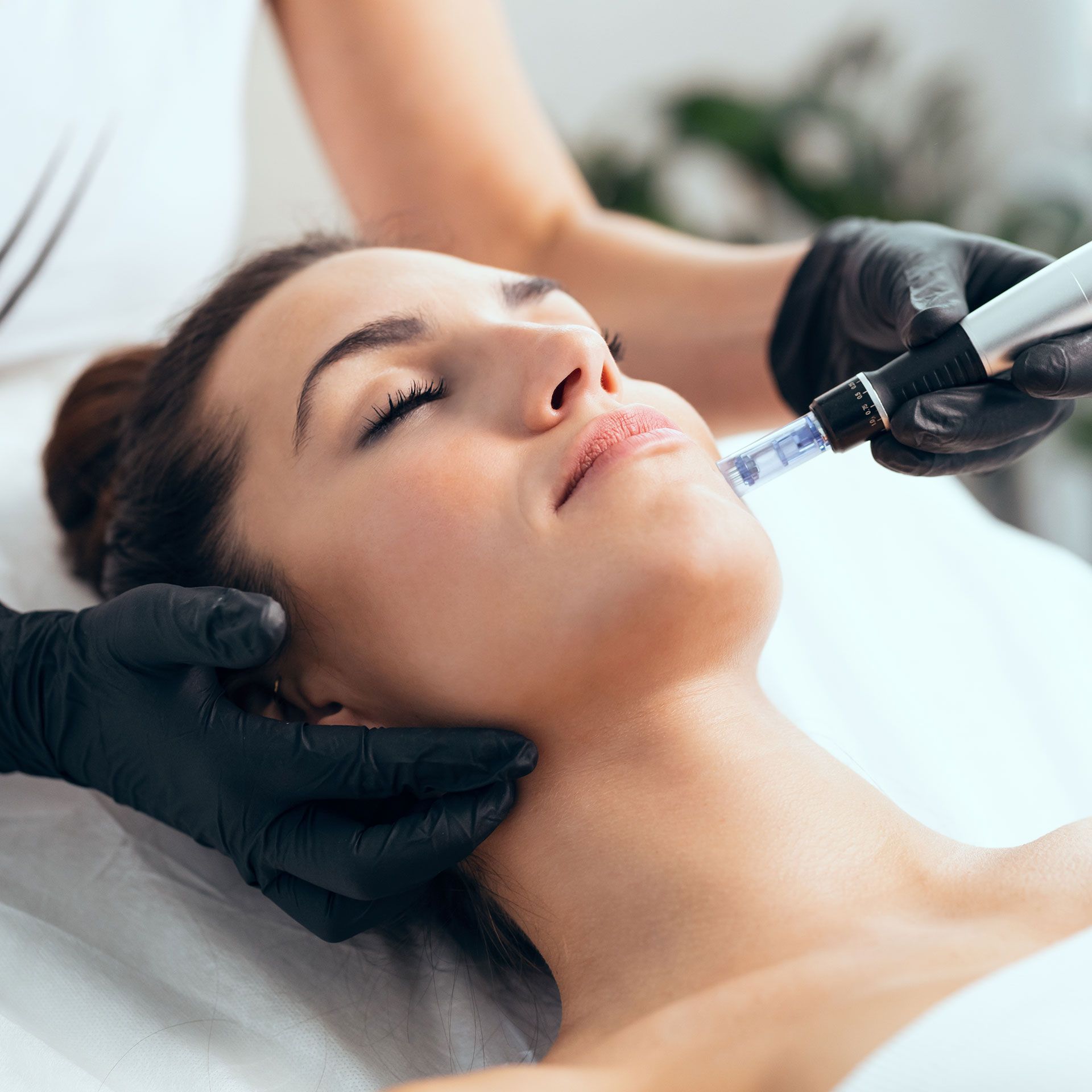 a woman is getting a treatment on her face