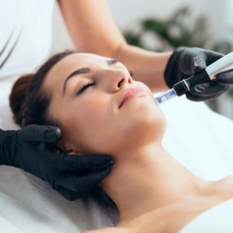 a woman is getting a treatment on her face