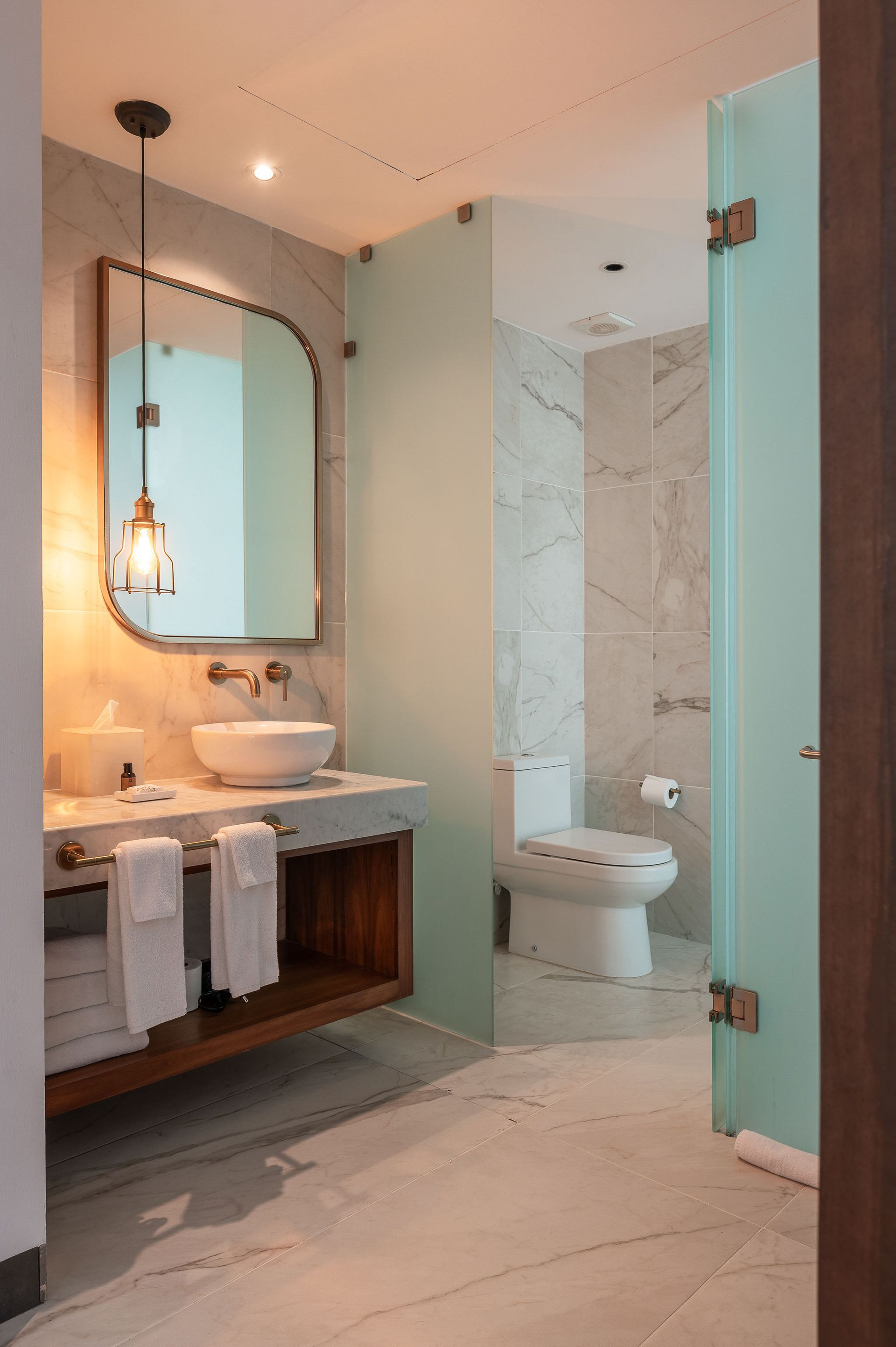 A bathroom with a sink , toilet and shower.