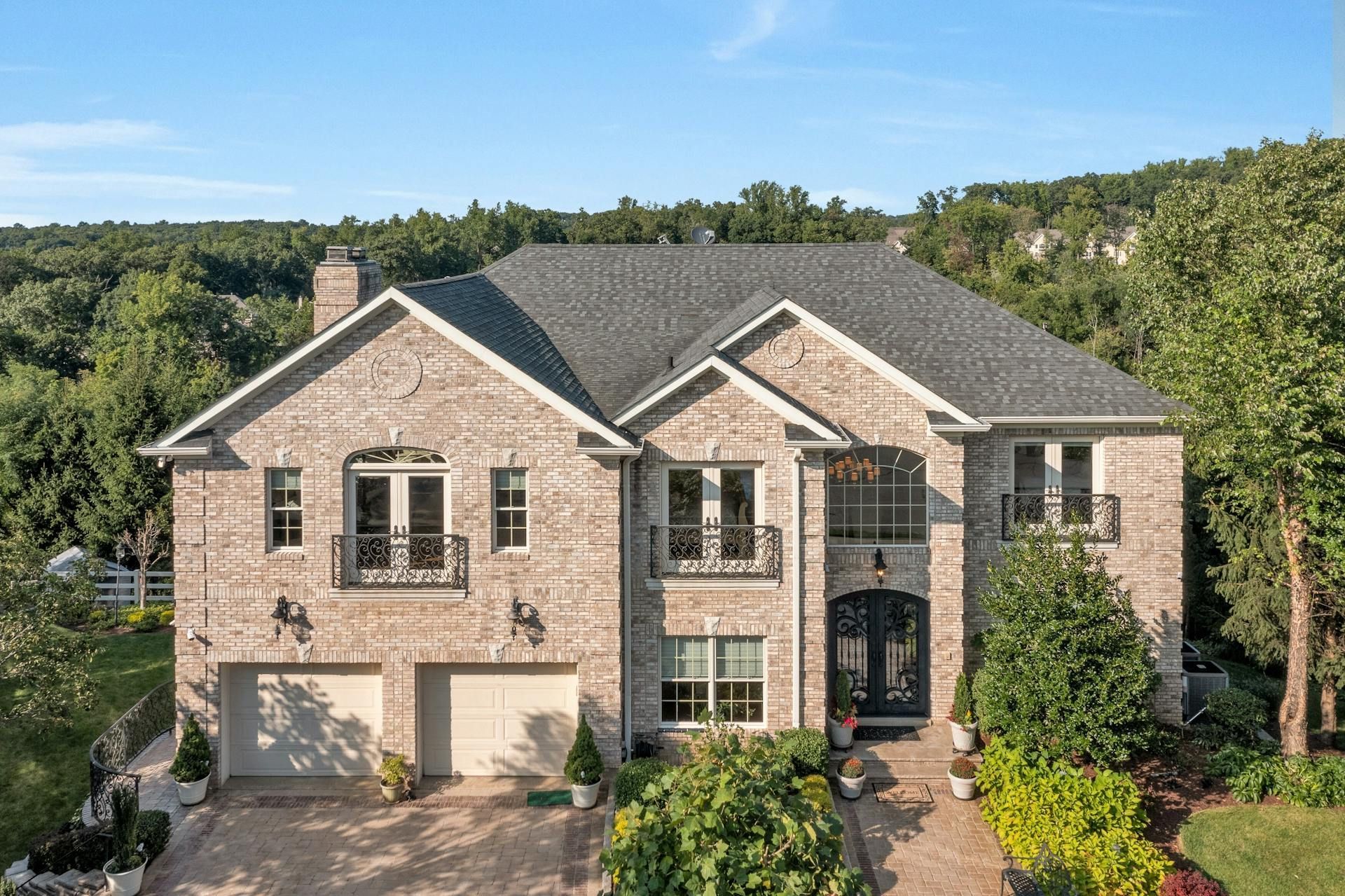 A dining room with a table and chairs and a wooden staircase.