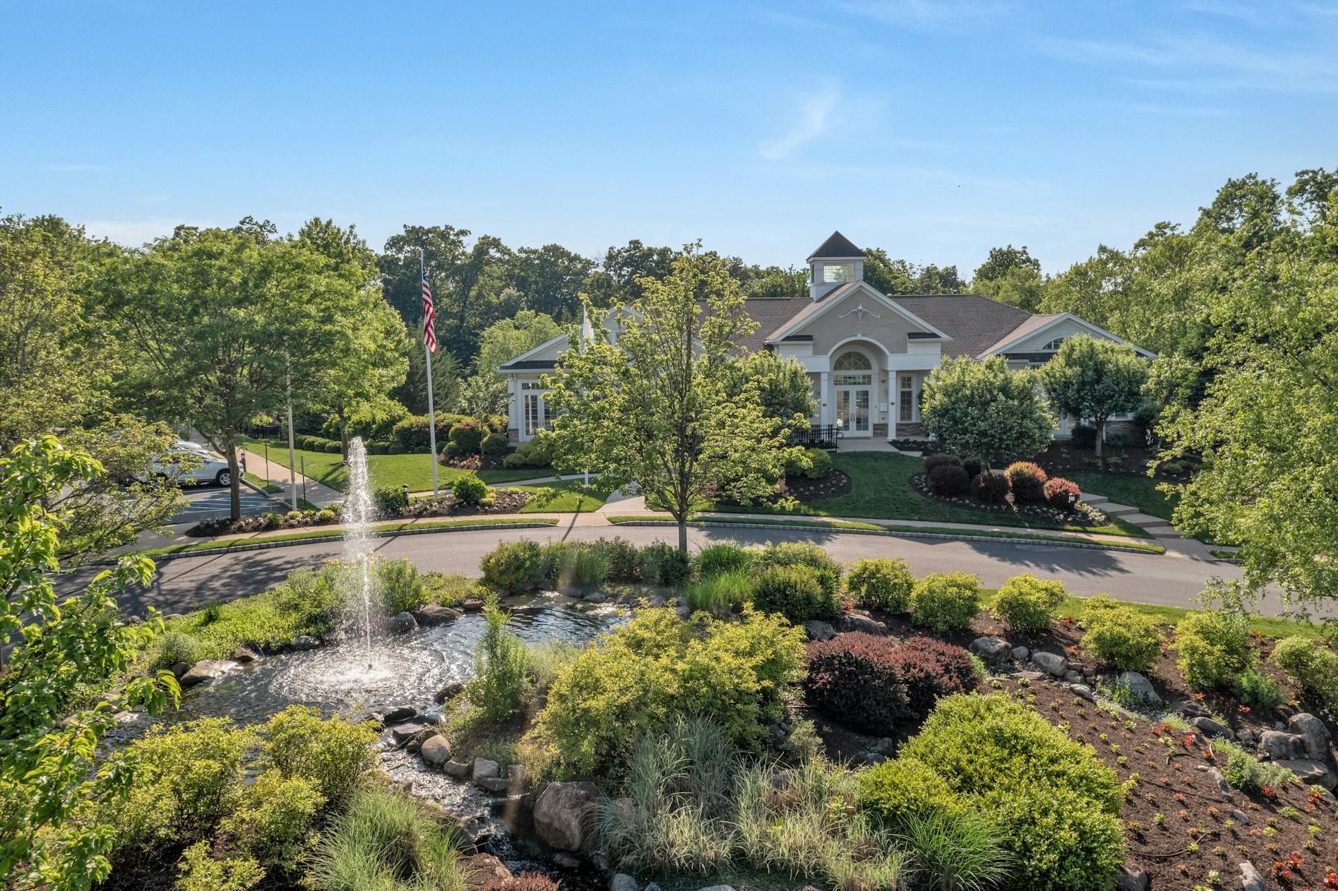 A patio with a lot of furniture and lights at night.