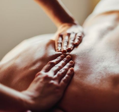 A person lying under a blue Celluma LED light therapy machine, undergoing a treatment.