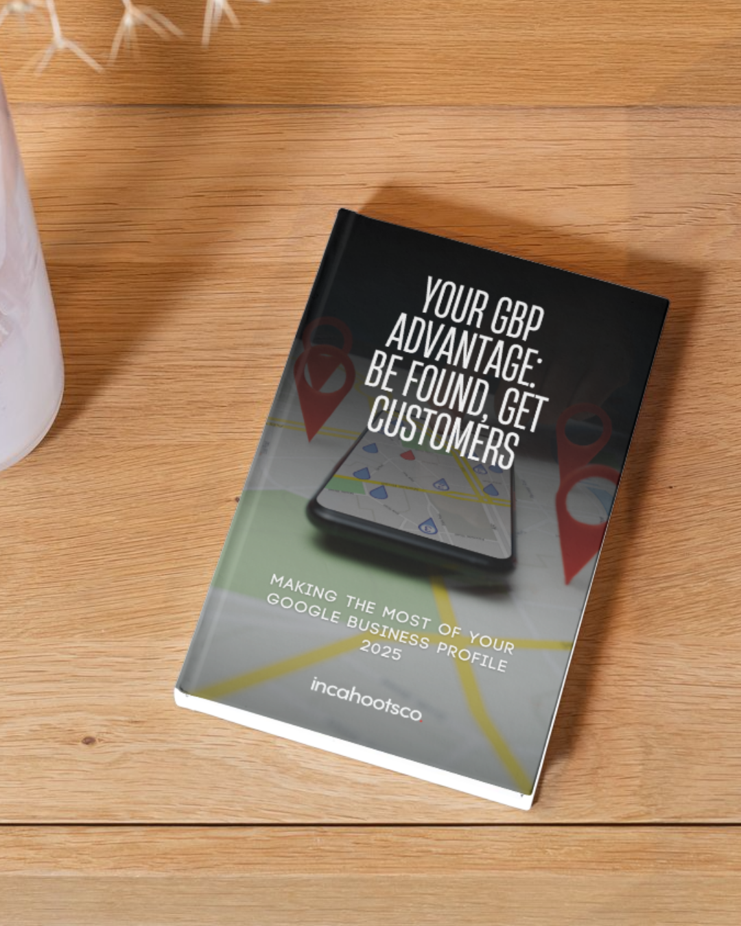 A book titled your gbp advantage be found get customers is sitting on a wooden table.