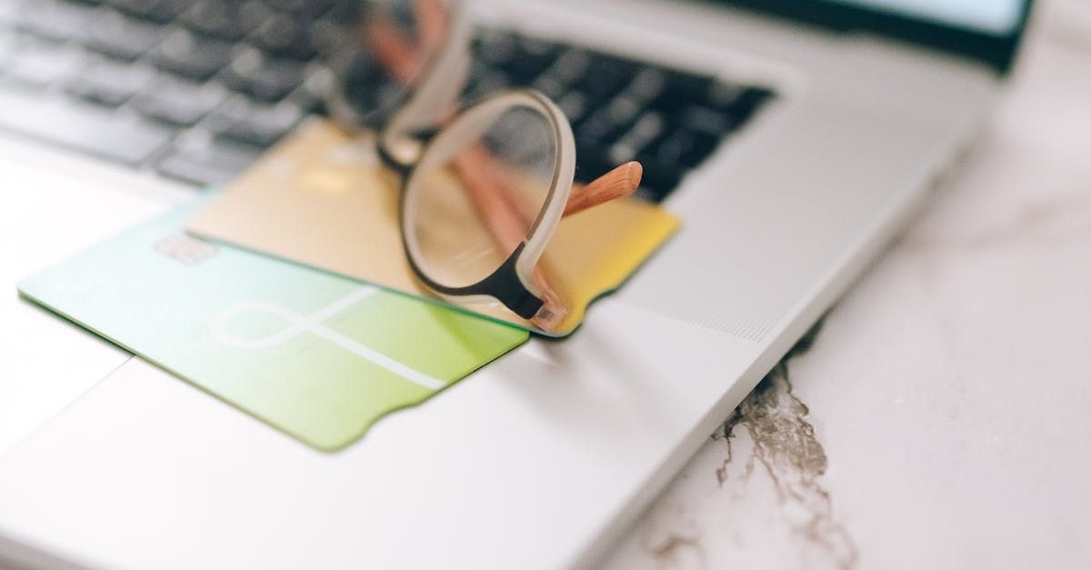 A pair of glasses is sitting on top of a laptop computer.