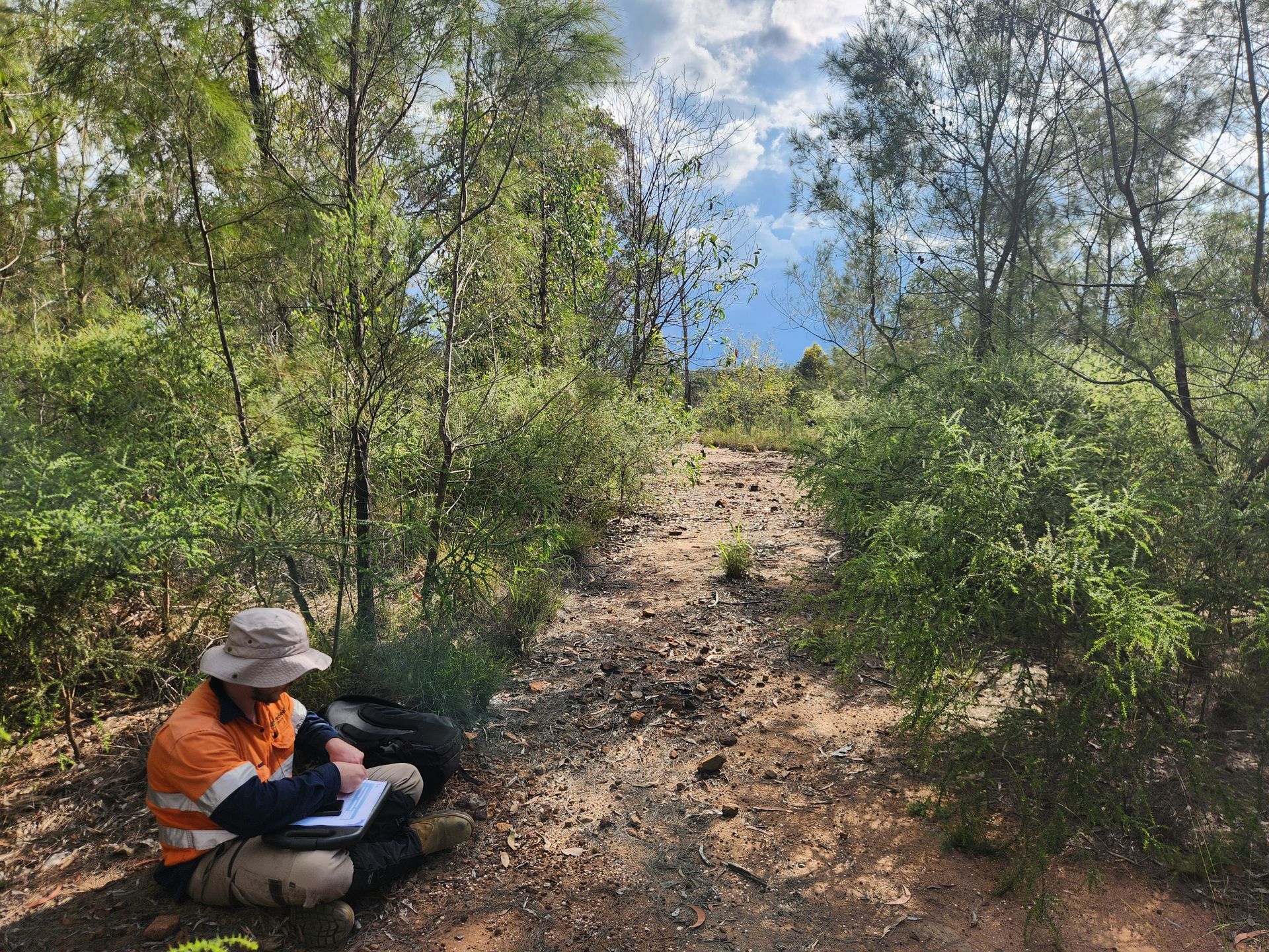 Ronan sitting down to record an ‘isolated find’, a single stone flake found on the exposed ground surface.