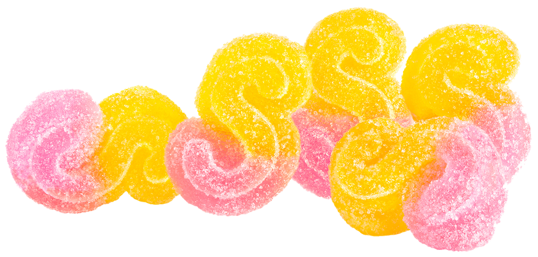 Pile of yellow and pink swirled gummy candies on a white background.
