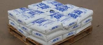 A wooden pallet filled with bags of salt.
