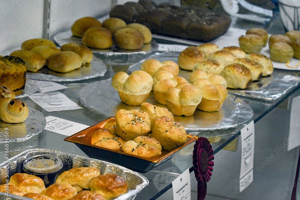 A variety of pastries are on display on a glass table