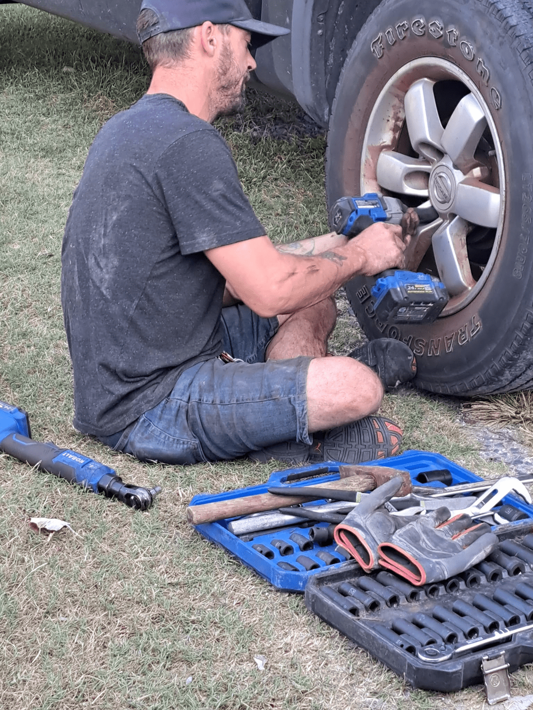 A yellow excavator is sitting on top of a pile of gravel.
