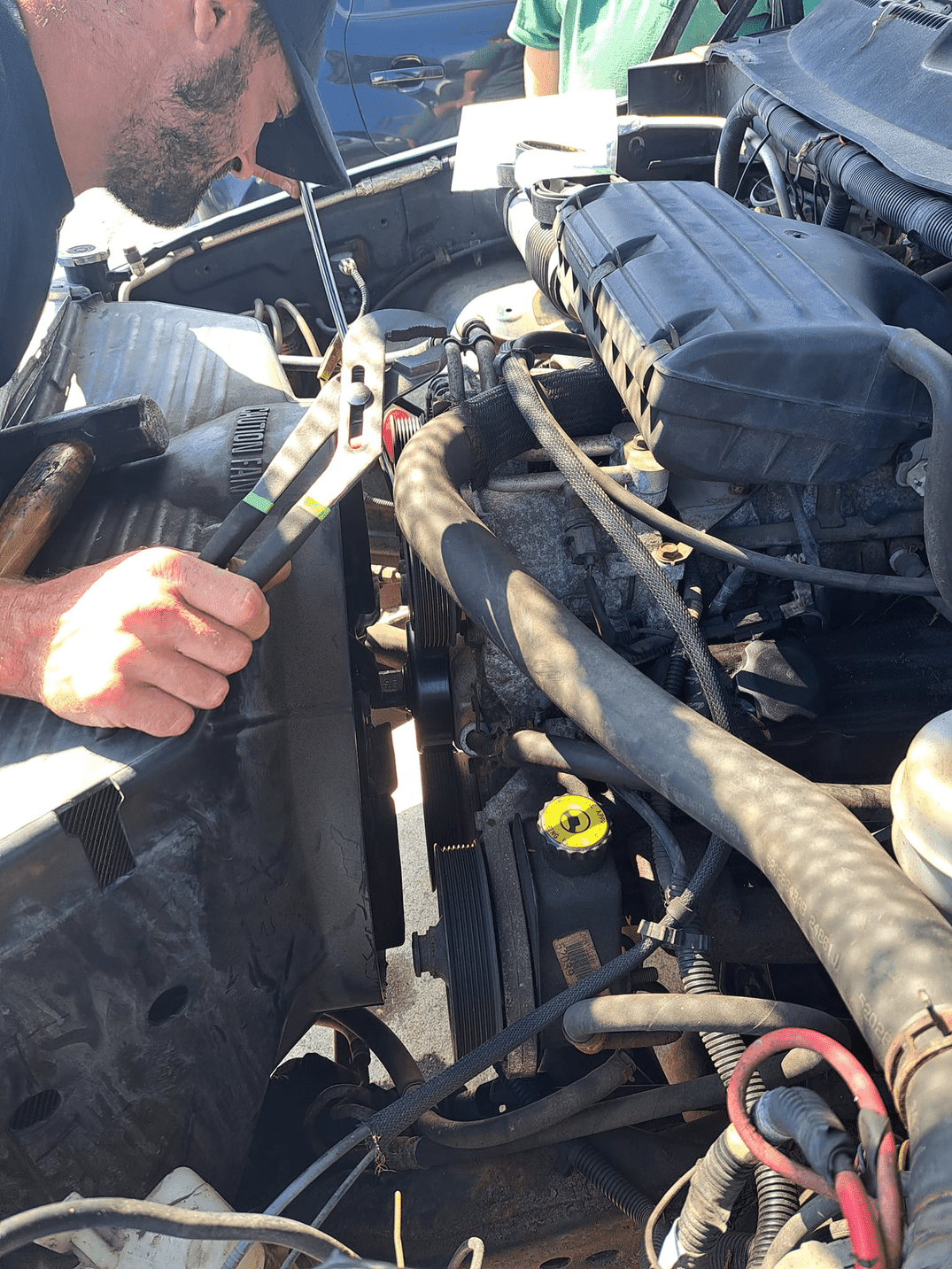 A man wearing a hard hat and goggles is standing in a room.