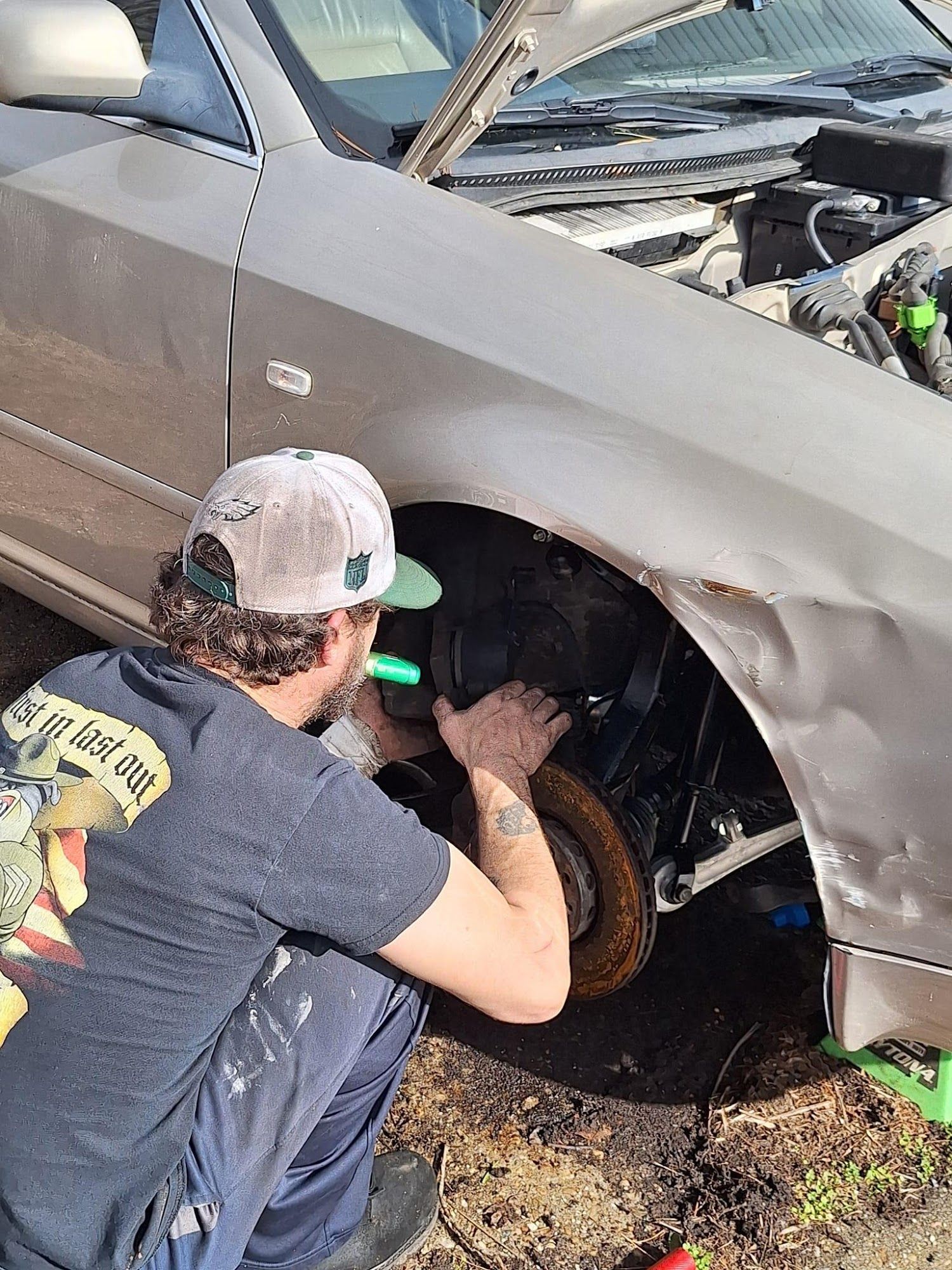 A yellow excavator is sitting on top of a pile of gravel.