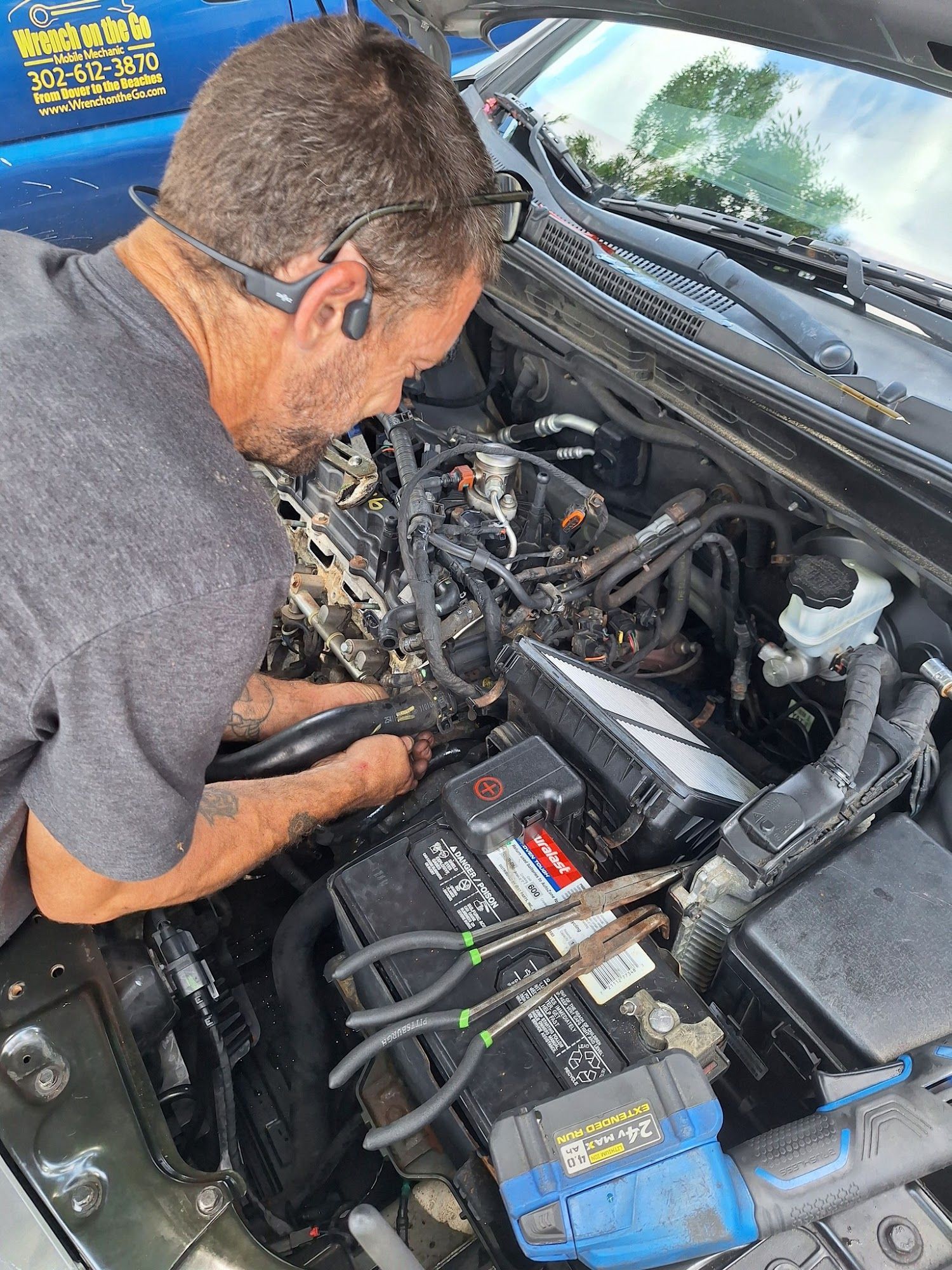 A yellow excavator is sitting on top of a pile of gravel.