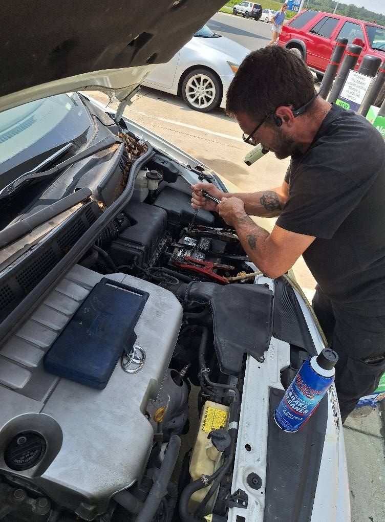 A man wearing a hard hat and goggles is standing in a room.